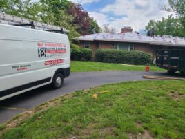 A white van parked in front of a house